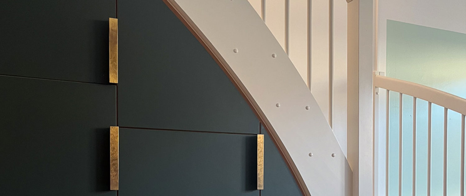 Udsnit af trappe og indbygget opbevaring Udsnit af hvid trappe og grønne linoleumslåger – skræddersyet køkkenopbevaring under trappe, Nordvest København